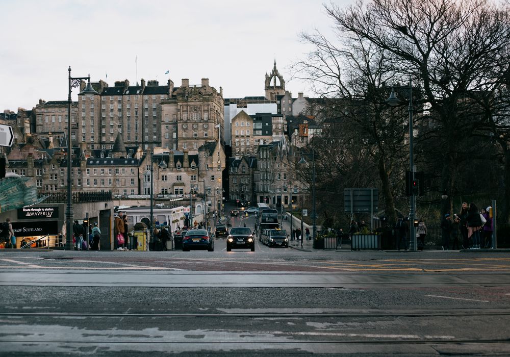 A taxi on an Edinburgh city-centre street below the Old Town